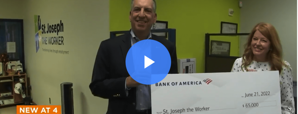 screenshot of a video news clip highlighting the funds received with a large format check presentation